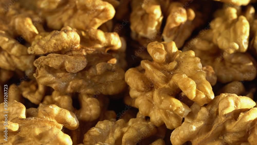 Walnut close up. product rich in minerals and vitamins. Walnut turns in a shot. Walnut kernels rotating. walnut close up lies under beams of the sun. Macro