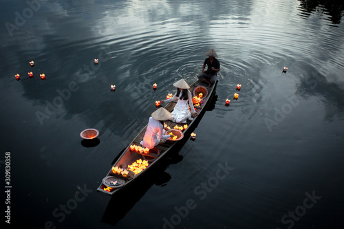 River lanterns and traditional Vietnamese dress, Hue,  Vietnam