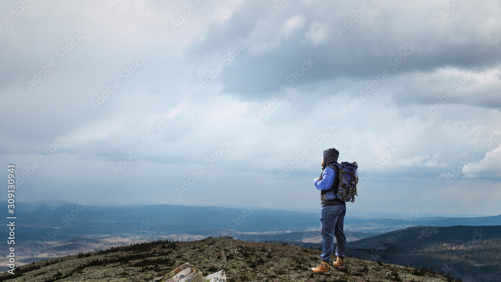 Fototapeta premium Hiker man in mountains. Mixed media