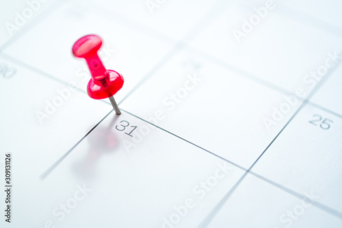 Red push pin on calendar 31st of the month, new year eve