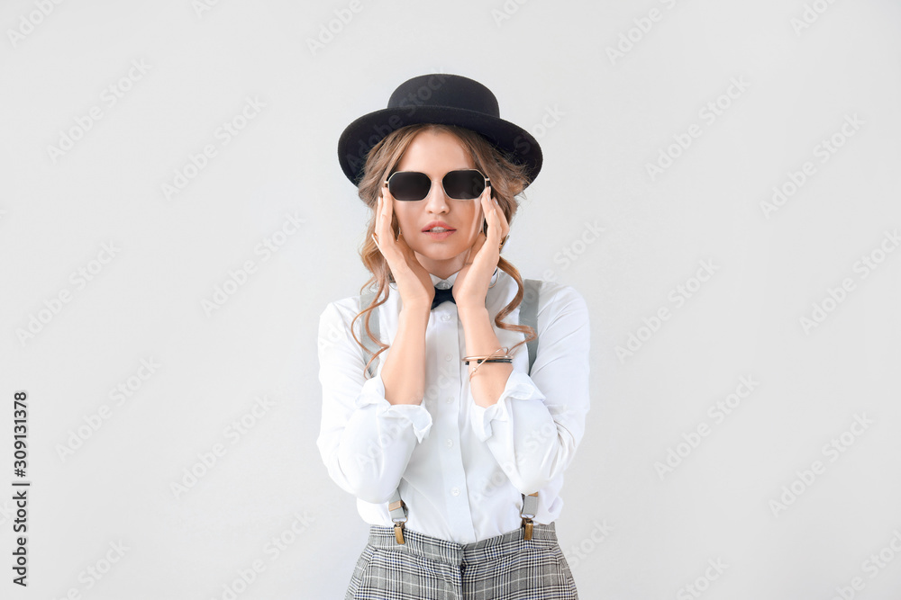 Fashionable young woman on light background Fashionable young woman on light background