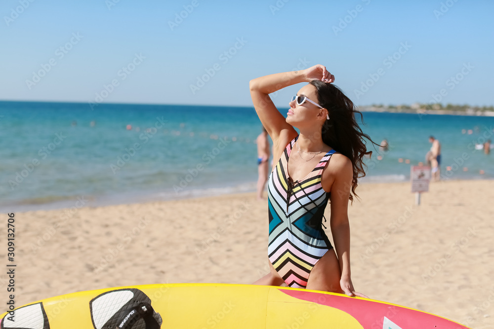 Beautiful woman on a sandy beach in sunglasses on background of ocean. Beautiful woman on a sandy beach in sunglasses on background of ocean.