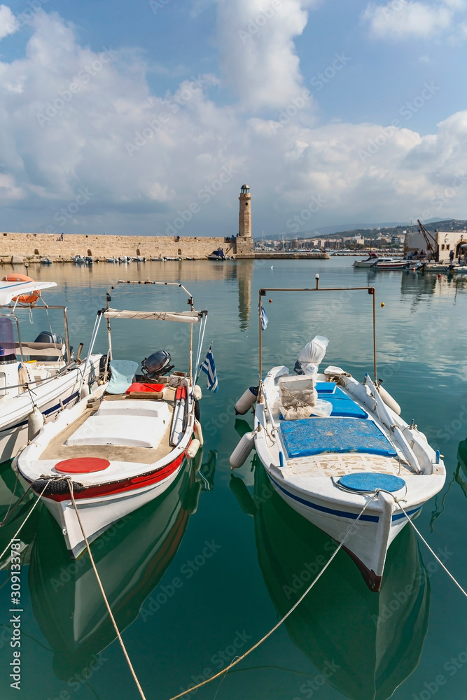 view of several small motor boats parked in a quiet harbor in the Greek town of Rethymnon