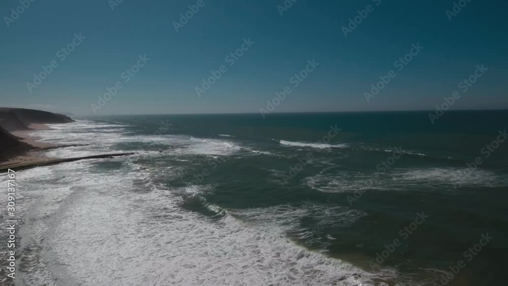 Beautiful and unique aerial shot across Rock formations in São Julião, Sintra, Portugal. Portuguese cinematic coast with crushing waves. Smooth, stable and 4K Beautiful and unique aerial shot across Rock formations in São Julião, Sintra, Portugal. Portuguese cinematic coast with crushing waves. Smooth, stable and 4K