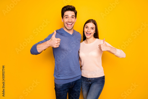 Portrait of two married people promoters hug embrace recommend advise discounts choice decision show thumb up sign wear blue pink sweater isolated over vivid color background