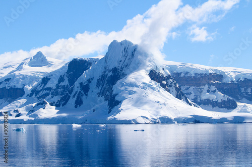 Snow-capped mountains on an island along the coasts of the Antarctic Peninsula, Palmer Archipelago, Antarctica