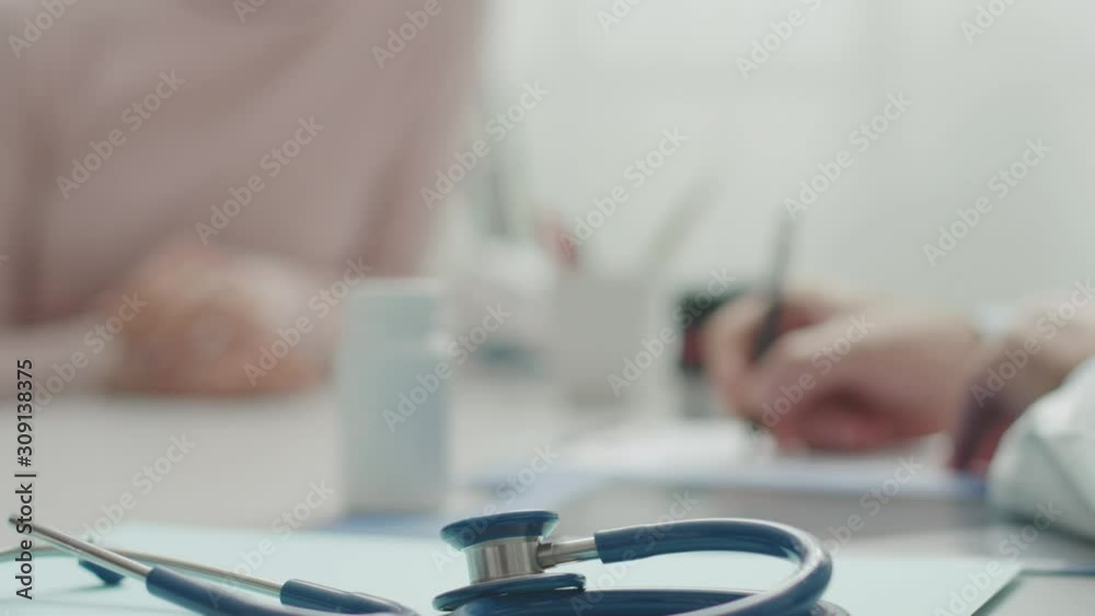Doctor giving a prescription to a patient Doctor giving a prescription to a patient
