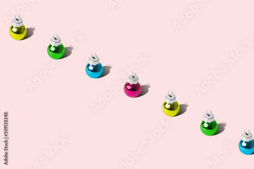 Multicolored Christmas ornaments abstract on pink background. © zphoto83