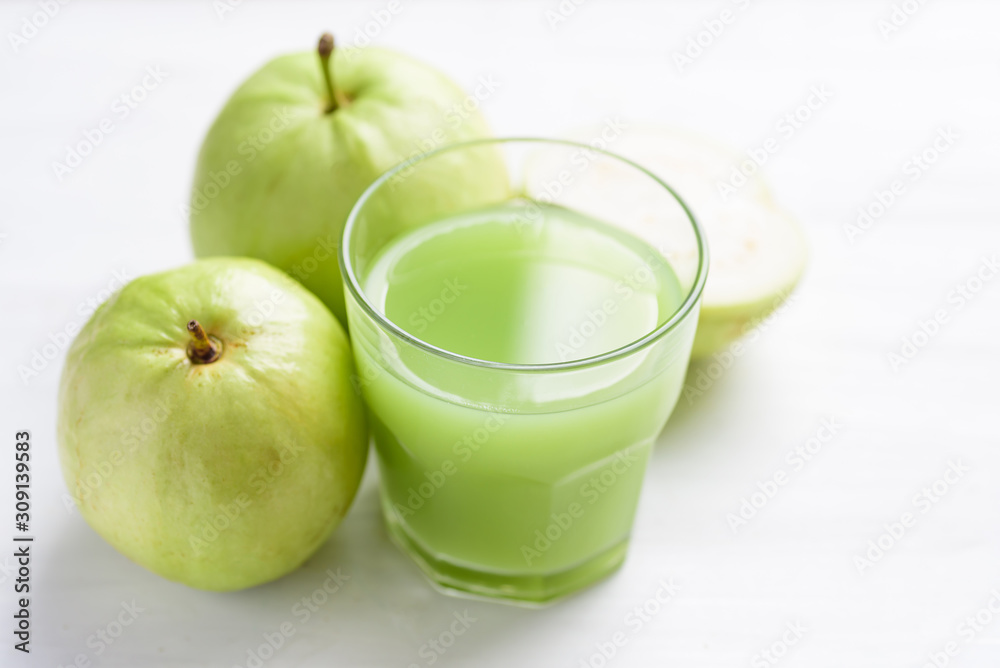 Green guava fruit and guava juice in glass on white background, high vitamin C healthy drink Green guava fruit and guava juice in glass on white background, high vitamin C healthy drink