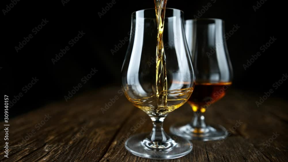 Super Slow Motion Shot of Pouring Rum into Glass at 1000fps with Camera Movement. Super Slow Motion Shot of Pouring Rum into Glass at 1000fps with Camera Movement.
