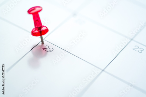 Red push pin on calendar 29th leap year day of the month