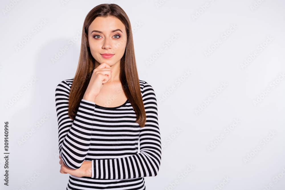 Portrait of charming woman touching her chin looking at camera wearing striped sweater isolated over white background Portrait of charming woman touching her chin looking at camera wearing striped sweater isolated over white background