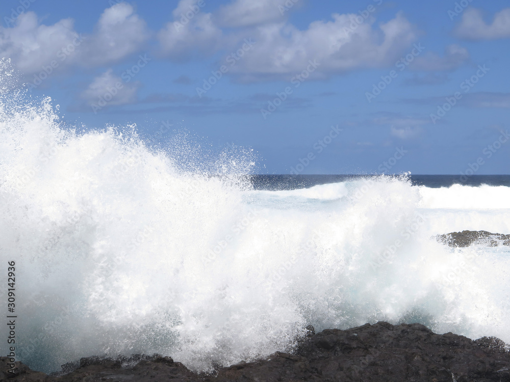 High waves crashing against lava rocks