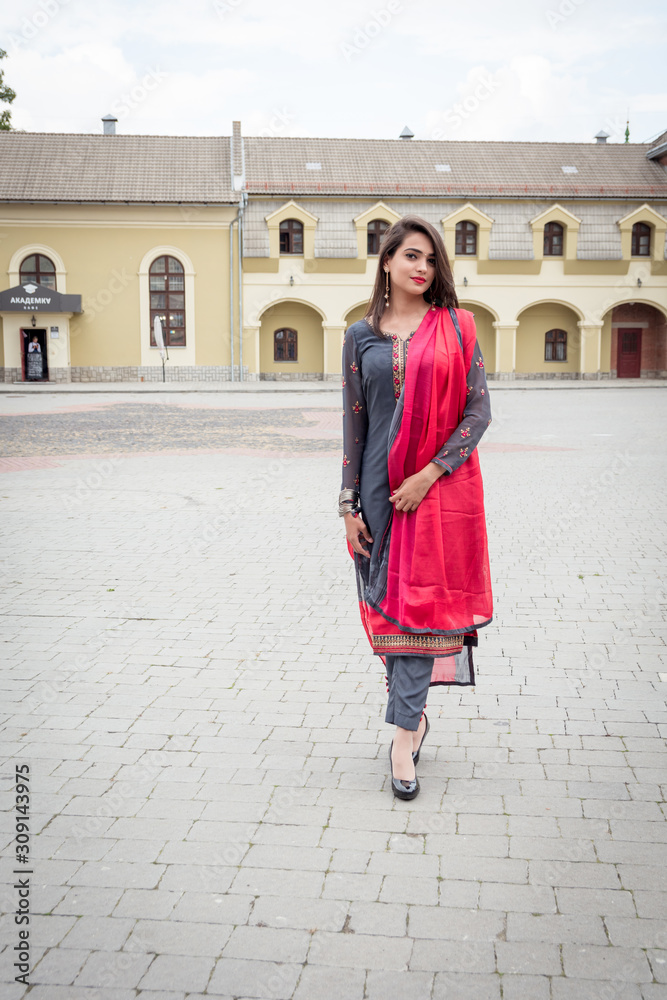 An Indian girl stands on the street of the city of Ivano-Frankivsk. Girl in traditional Indian clothing, salwar kameez.