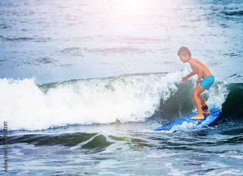 Photography Little boy in surfing school learn to surf waves