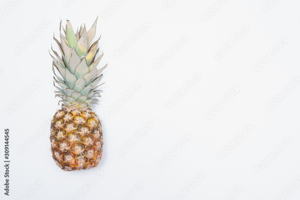 Pineapple on a white stone surface background with copy space. Pineapple on a white stone surface background with copy space.