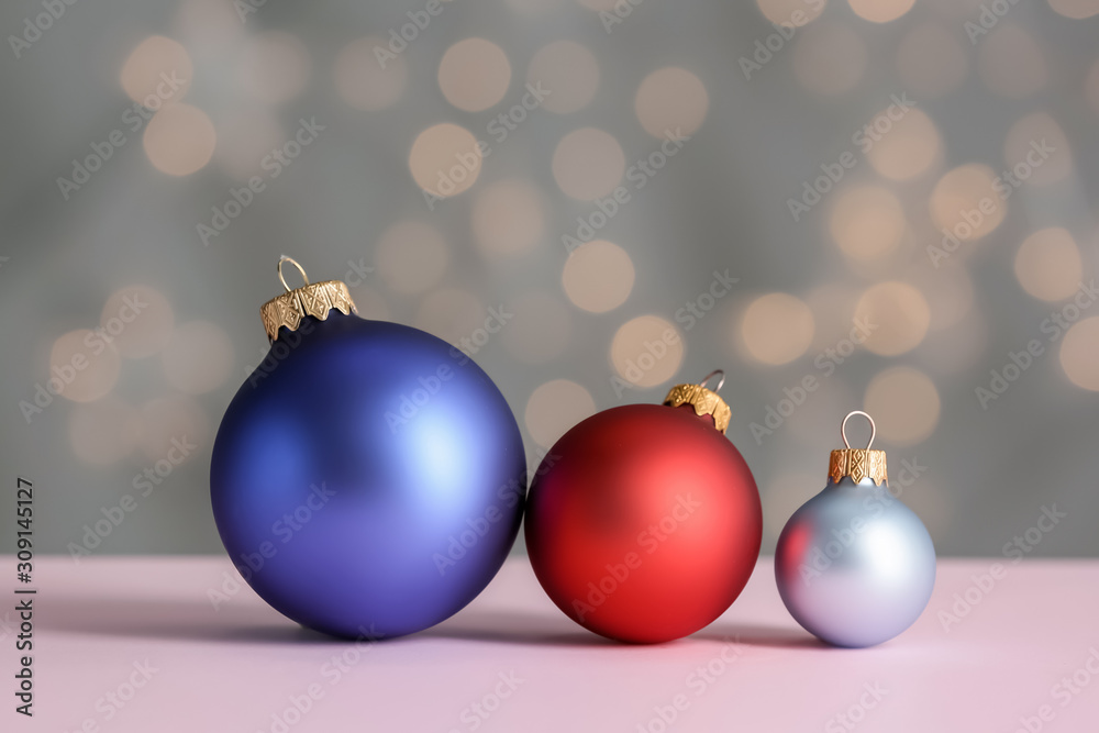 Beautiful Christmas balls on table against blurred lights Beautiful Christmas balls on table against blurred lights