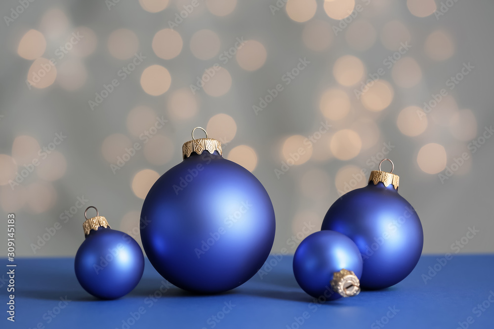 Beautiful Christmas balls on table against blurred lights Beautiful Christmas balls on table against blurred lights