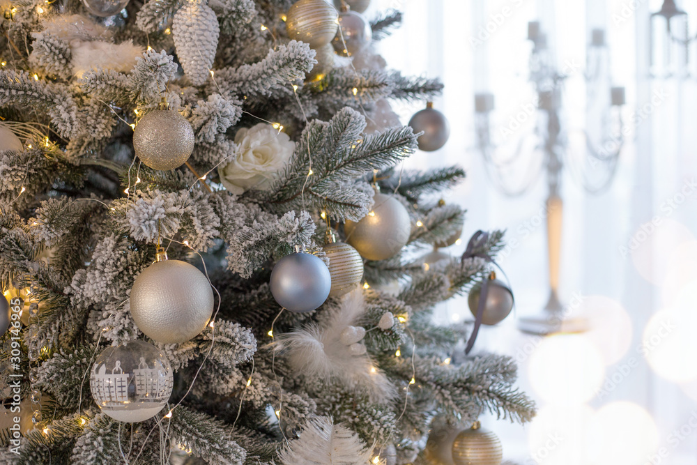 Christmas tree decorated in retro style with white, silver and blue balls, feathrs, christmas cones. Place for text Christmas tree decorated in retro style with white, silver and blue balls, feathrs, christmas cones. Place for text