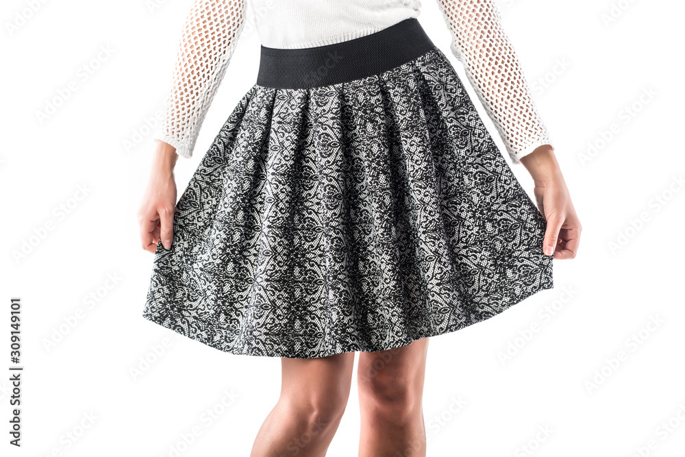 Model holds in her hands her beautiful plaid skirt Model holds in her hands her beautiful plaid skirt