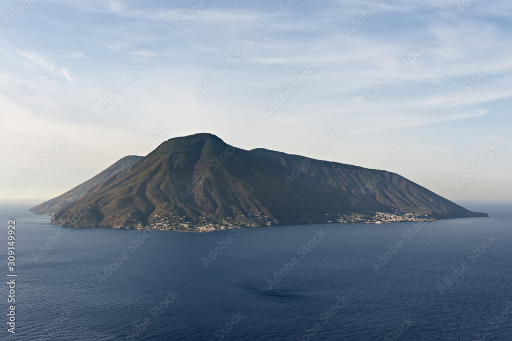 beautiful volcanic salina aeolian island, calm sea and blue cloudy sky background beautiful volcanic salina aeolian island, calm sea and blue cloudy sky background
