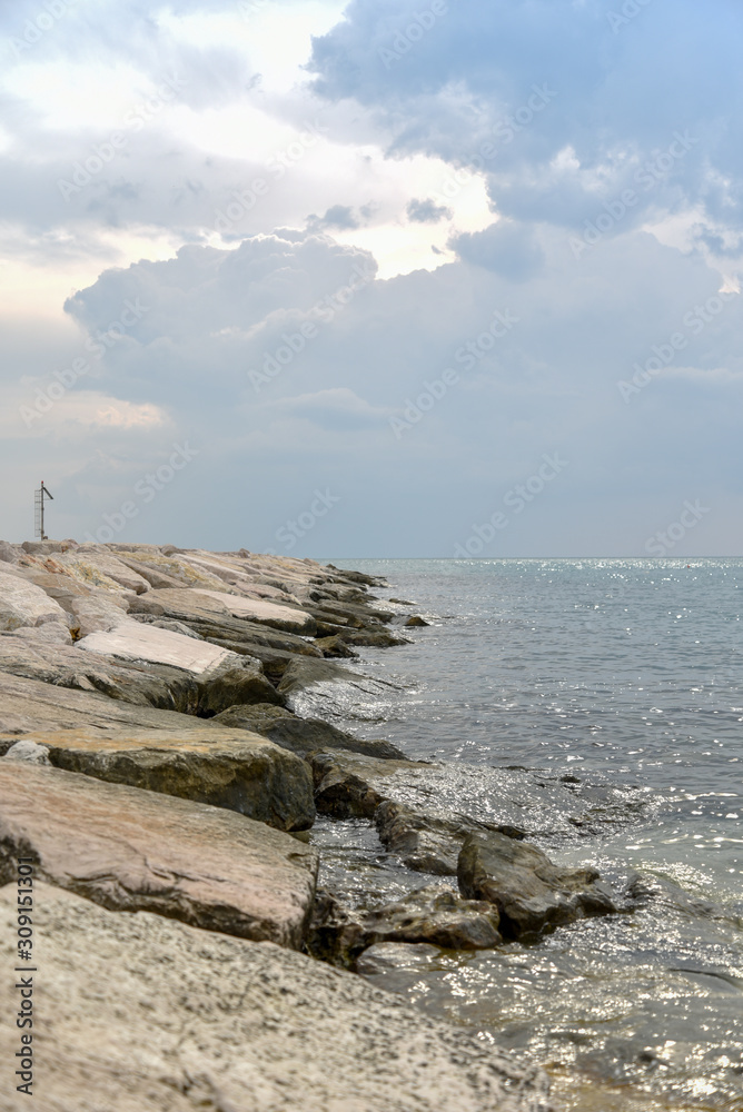 Rocks in the Beach of Mattinata with Cloudy Sky Rocks in the Beach of Mattinata with Cloudy Sky