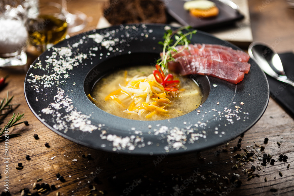 Clear Fish soup served in a bowl in restaurant