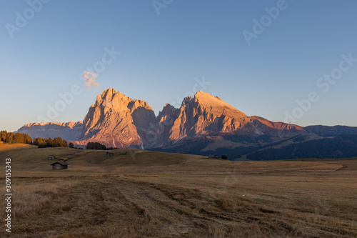 Sunset landscapes on Alpe di Siusi with Sassolungo or Langkofel Mountain Group in Background in autumn, South Tyrol, Italy