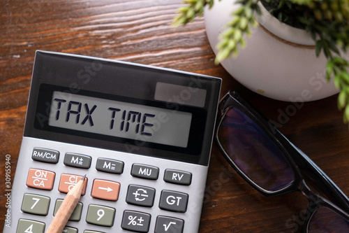 Calculator with text Tax Time. Business, finance conceptual. 