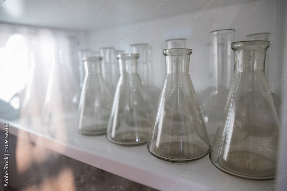 white orchid flower on glass flask and test tube in science cosmetic biology laboratory background white orchid flower on glass flask and test tube in science cosmetic biology laboratory background