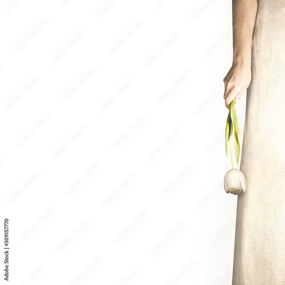 woman holds along the body the flower that has just been given her woman holds along the body the flower that has just been given her