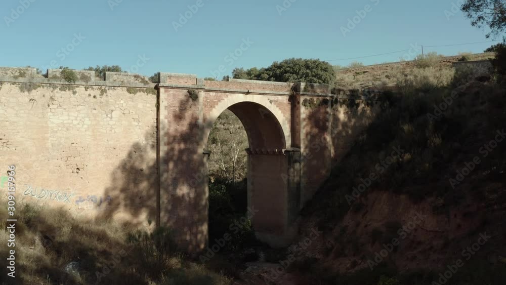 Old arch in Spain, showing old structures in dry landscape. Old arch in Spain, showing old structures in dry landscape.