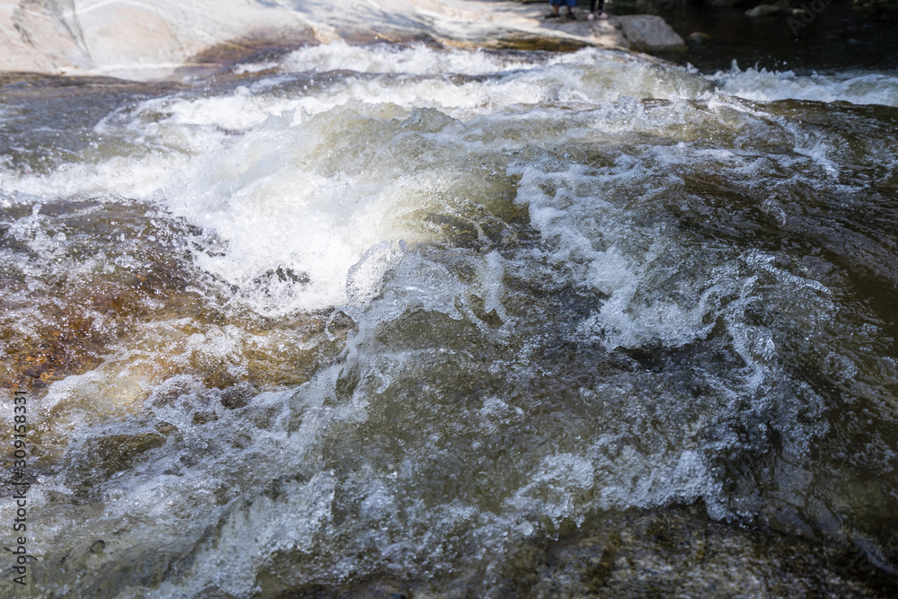 Calm water stream around the rocks Calm water stream around the rocks