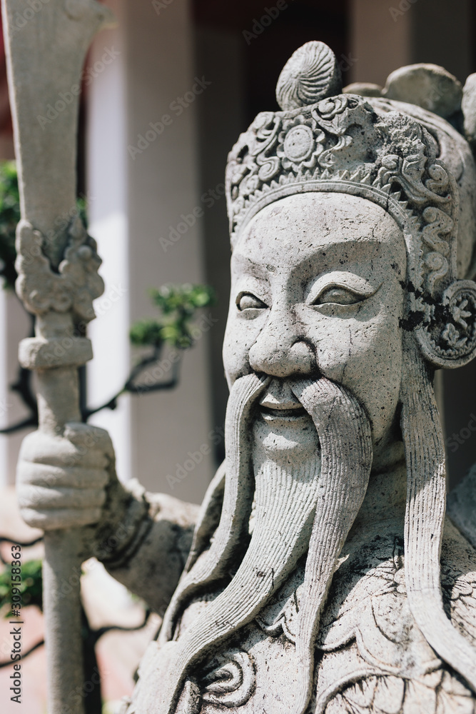 Closeup of stone statue in temple in Bangkok, Thailand