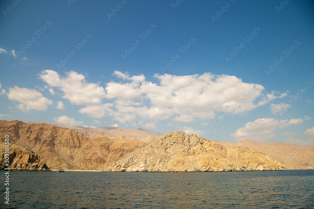 mountains of Oman on the sea against the blue sky