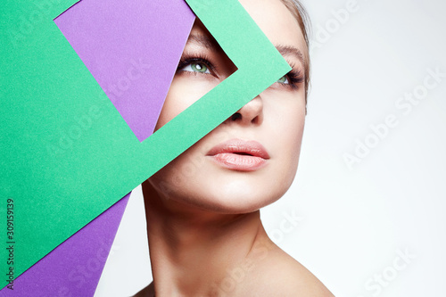 Beautiful young woman with color paper