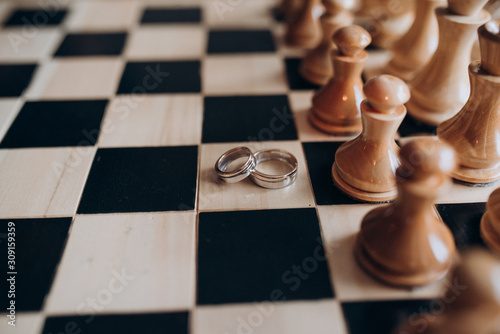 wedding rings lie on the chessboard