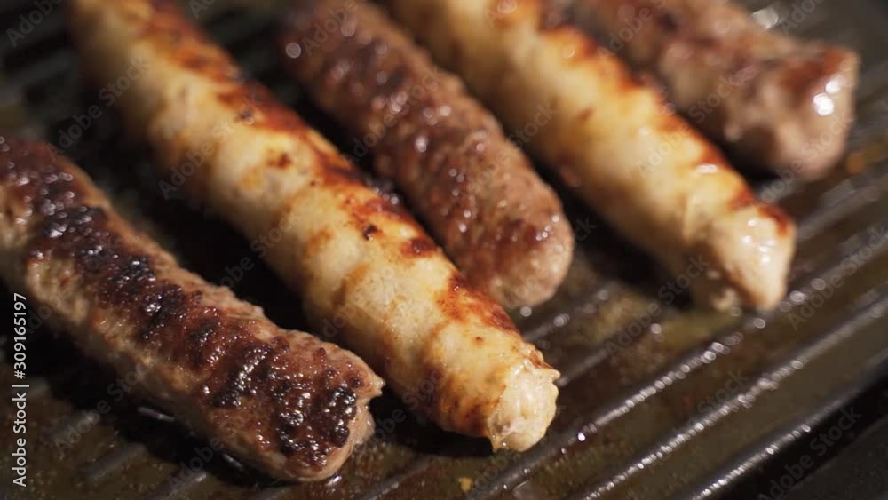 Street Food Cooking on Big Frying Pan. Appetizing Barbecue Sausages Cooking in Outdoor Kitchen. Street Food Cooking on Big Frying Pan. Appetizing Barbecue Sausages Cooking in Outdoor Kitchen.