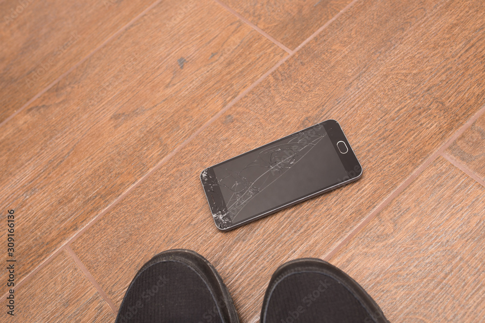 The black smartphone fell out of my hands and the screen crashed to smithereens. The black smartphone fell out of my hands and the screen crashed to smithereens.