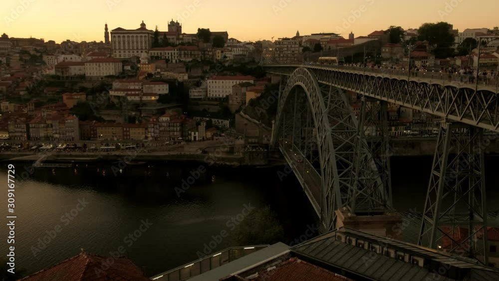 Tram, cars and pedestrians cross the Ponte Luis I bridge in Porto at sunset. Tram, cars and pedestrians cross the Ponte Luis I bridge in Porto at sunset.
