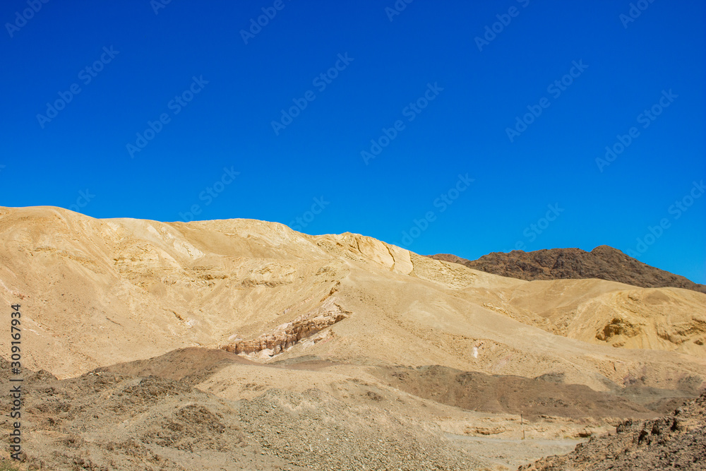 Negev Israeli desert sand stone hill dry wilderness scenic landscape environment with horizon rocky view background in clear weather summer time 