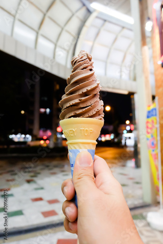 A hand holding ice cream soft cream