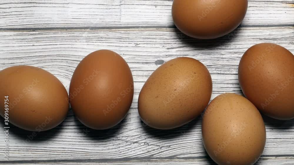 Brown Eggs On Kitchen Wooden Table Panning Slider Shot Top View.