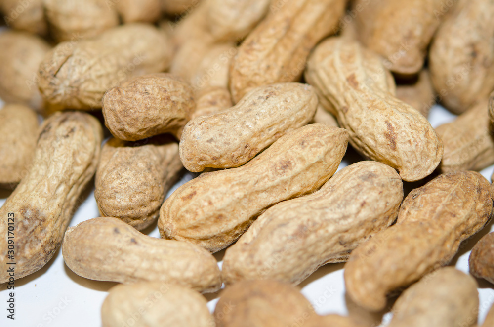 Unshelled peanuts close-up. Lots of nuts, vegan, natural food. Unshelled peanuts close-up. Lots of nuts, vegan, natural food.