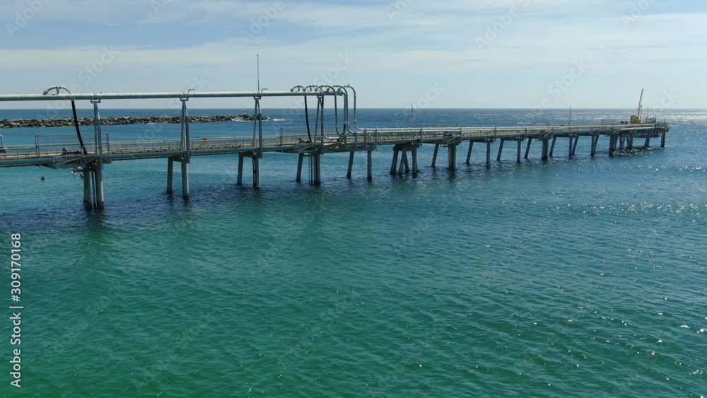Long panning view of the Gold Coasts sand pumping jetty, the only permanent facility of its king in Australia. Slow peaceful waves rolling in. Queensland Long panning view of the Gold Coasts sand pumping jetty, the only permanent facility of its king in Australia. Slow peaceful waves rolling in. Queensland