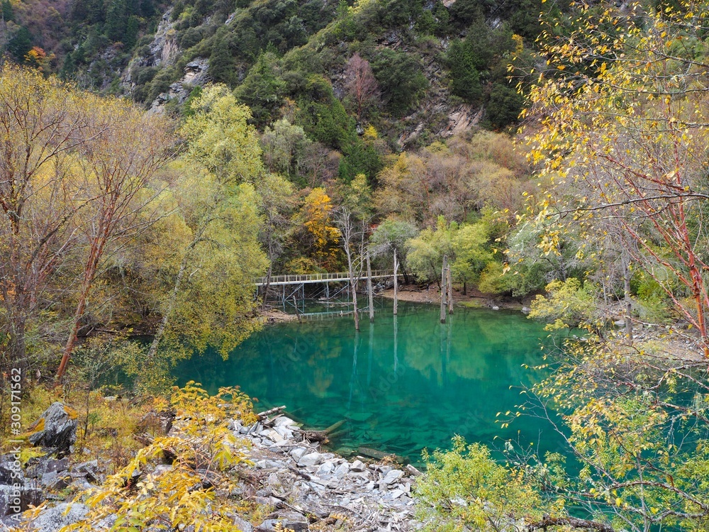 Fototapeta premium Blue lake and colorful forest of plateau in Songpinggou Scenic Area, Sichuan Province, China