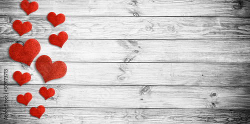 Valentine's day background with red hearts on wooden planks