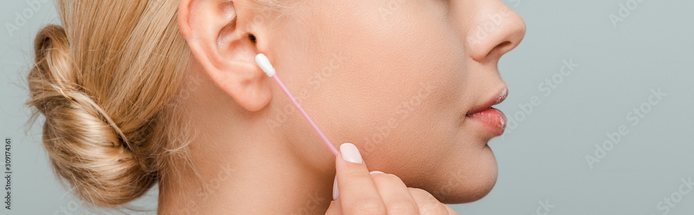 panoramic shot of woman holding ear stick isolated on grey panoramic shot of woman holding ear stick isolated on grey