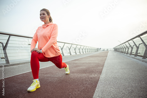 Charming sporty lady stretching legs on the bridge © Viacheslav Yakobchuk