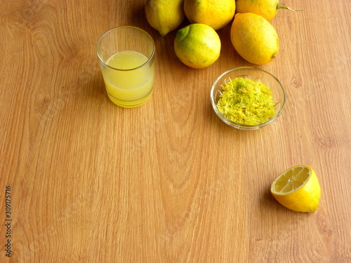 Wallpaper Mural lemon juice in a glass, lemon zest and whole lemons on a wooden table Torontodigital.ca